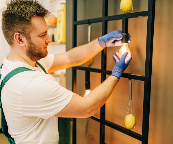 electrician-changes-the-light-bulb-handyman-resize.jpg electrician-changes-the-light-bulb-handyman-resize.jpg